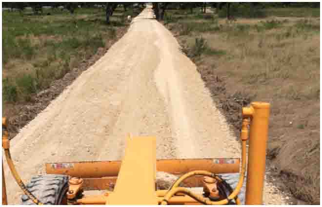 Completed compacted road-base drive through a rural property