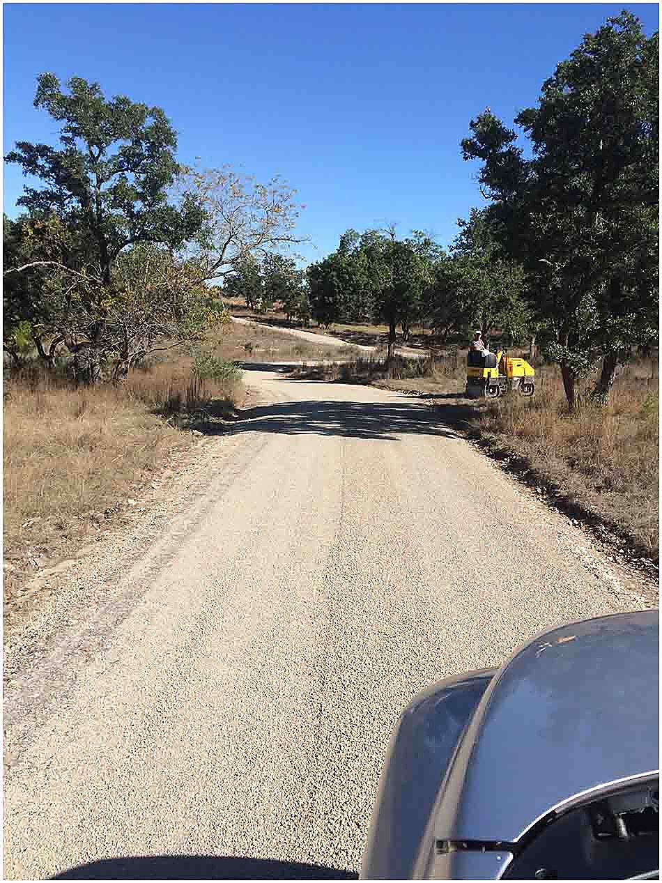 Completed chip-seal ranch road through a wooded property